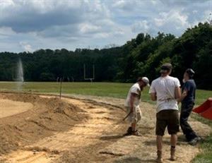 operations workers turn a field over the summer